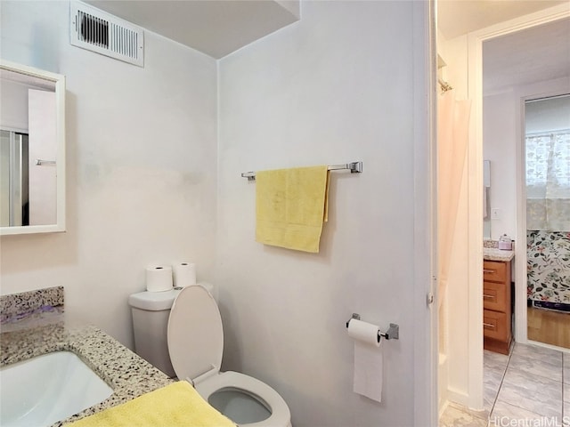 bathroom featuring toilet and vanity