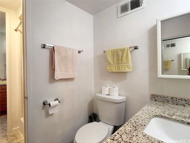 bathroom with tile patterned flooring, vanity, and toilet