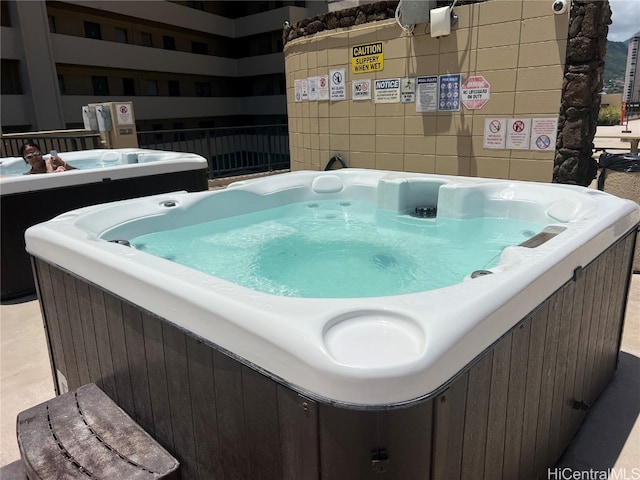 view of pool with a hot tub