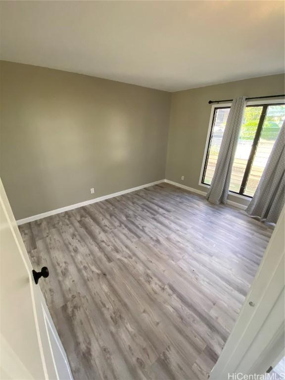 spare room featuring light wood-type flooring