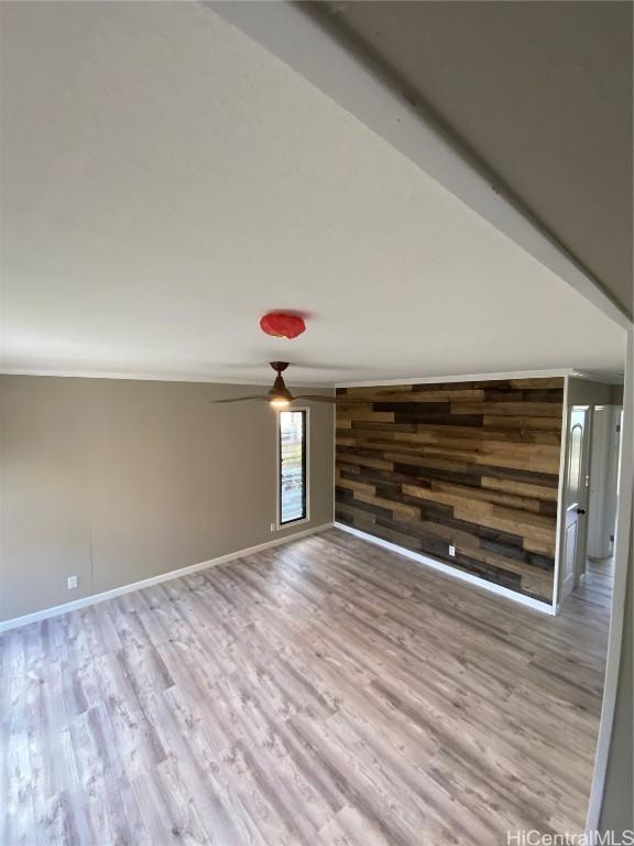 interior space featuring light hardwood / wood-style floors and wooden walls