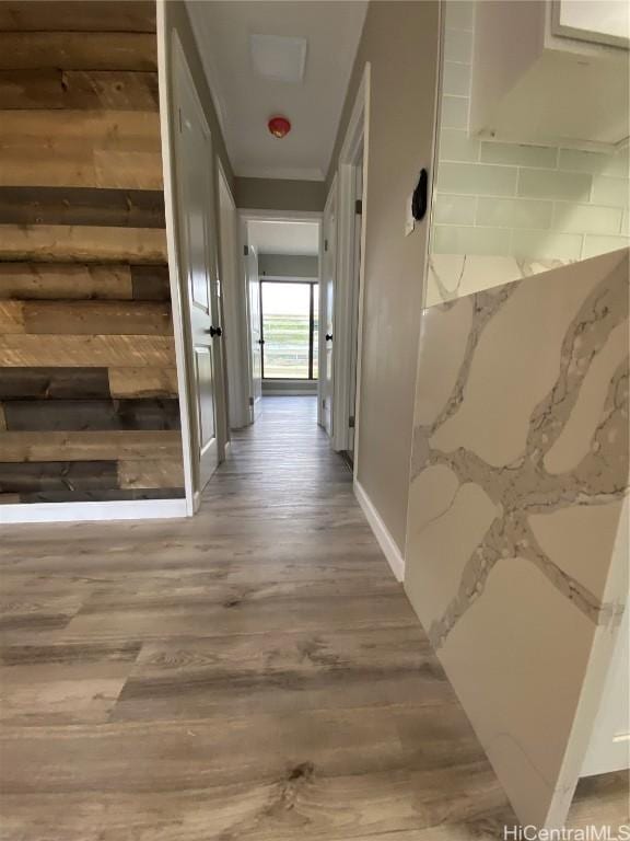 hall featuring crown molding and hardwood / wood-style flooring