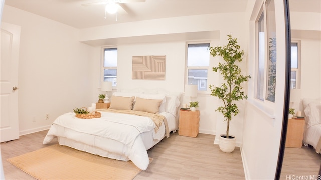 bedroom with ceiling fan and light hardwood / wood-style floors