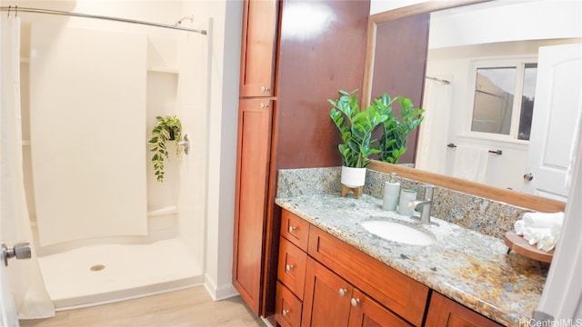 bathroom with hardwood / wood-style floors, vanity, and a shower with curtain