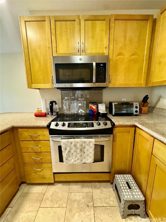 kitchen with light stone countertops and white electric stove