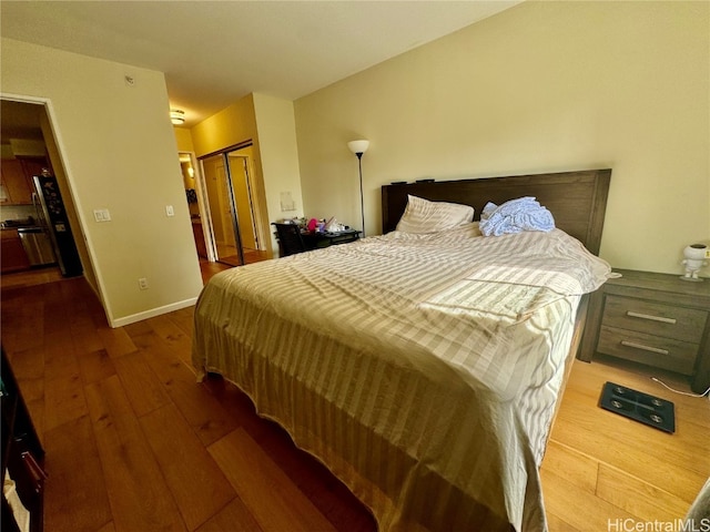 bedroom with a closet and hardwood / wood-style floors