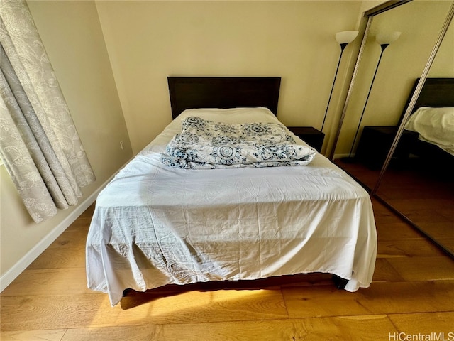 bedroom featuring hardwood / wood-style flooring and a closet