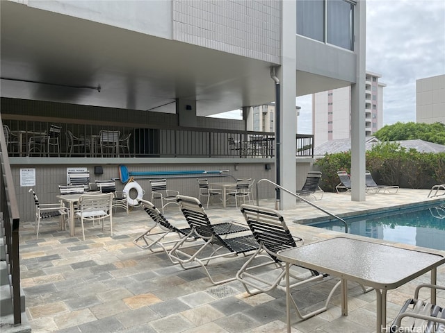 view of pool with a patio and ceiling fan