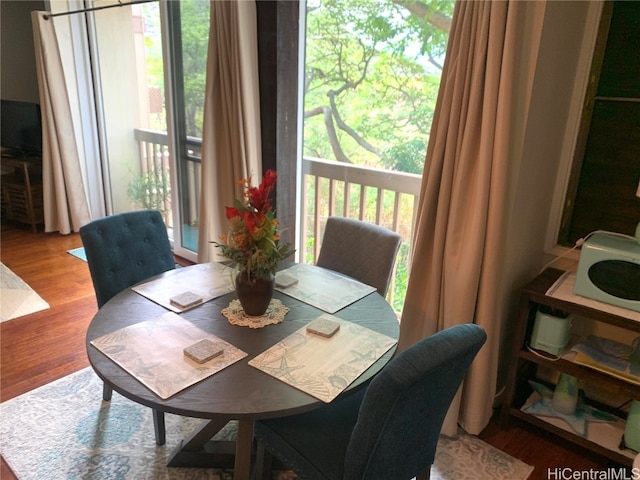 dining area with a healthy amount of sunlight and hardwood / wood-style floors