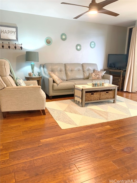 living room with ceiling fan and wood-type flooring