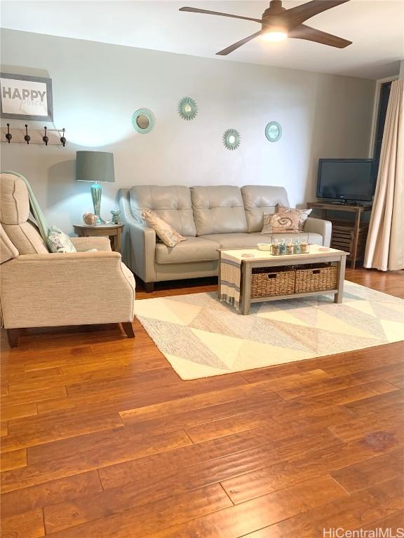 living room featuring ceiling fan and hardwood / wood-style flooring