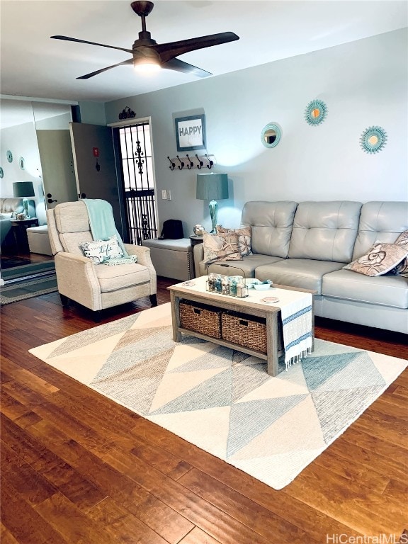 living room with wood-type flooring and ceiling fan