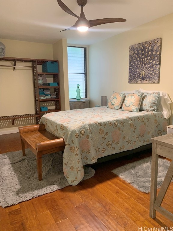 bedroom with ceiling fan and wood finished floors