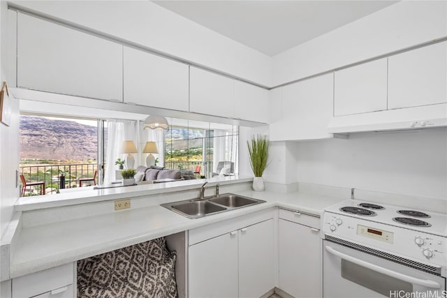 kitchen featuring white cabinets, sink, and electric stove