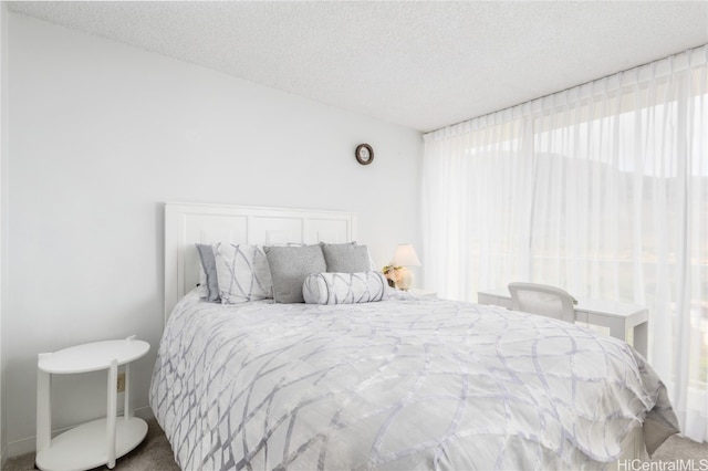 bedroom with a textured ceiling and carpet flooring