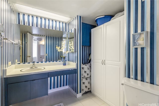 bathroom featuring vanity, tile patterned floors, and toilet