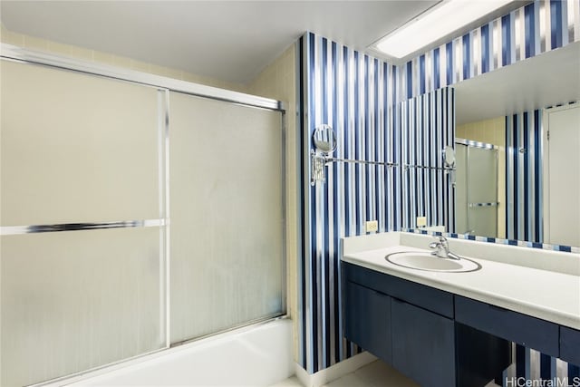 bathroom with vanity and shower / bath combination with glass door