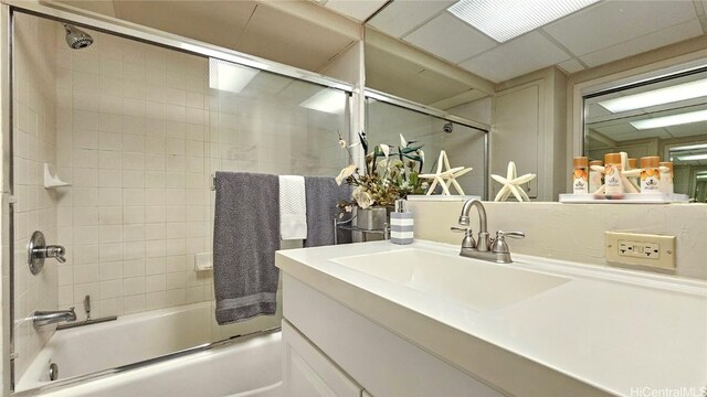 bathroom with enclosed tub / shower combo and vanity