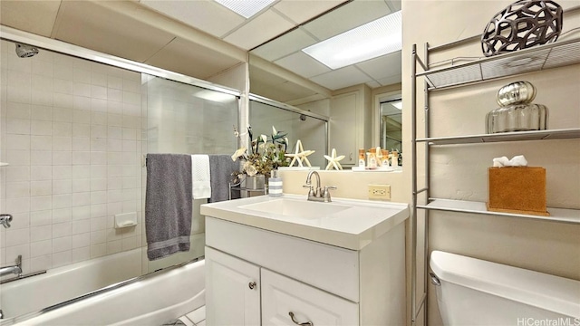 full bath with shower / bath combination with glass door, vanity, and toilet