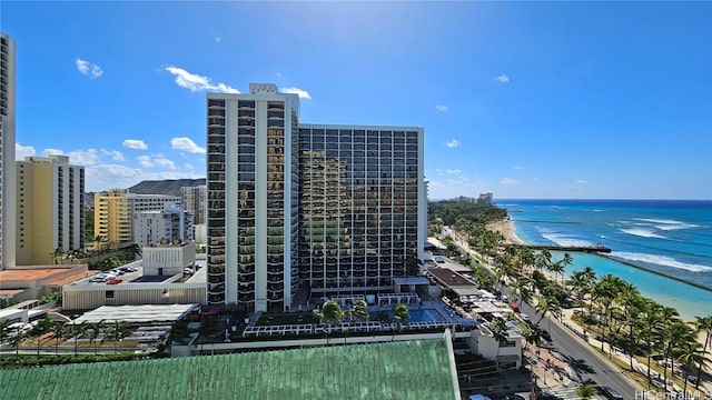 view of building exterior featuring a beach view and a water view