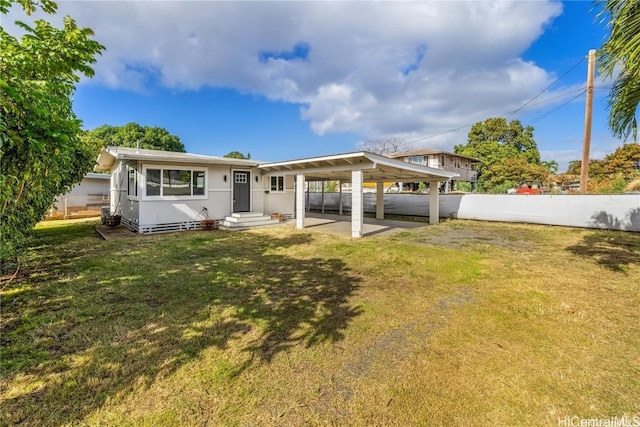 back of property featuring a lawn and a patio area