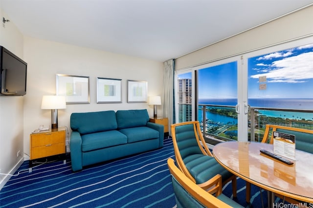 living room featuring a water view and dark colored carpet