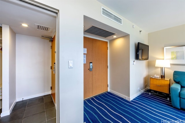 interior space featuring dark tile patterned flooring