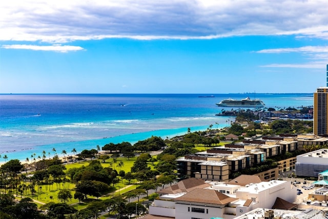 birds eye view of property with a water view and a beach view