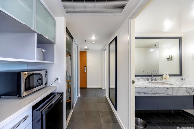 410 Atkinson Dr Unit 3007, Honolulu, HI 96814 - hallway featuring a sink, dark tile patterned floors, beverage cooler, recessed lighting, and baseboards
