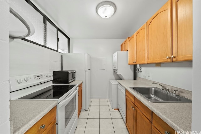 kitchen with light tile patterned flooring, white appliances, and sink