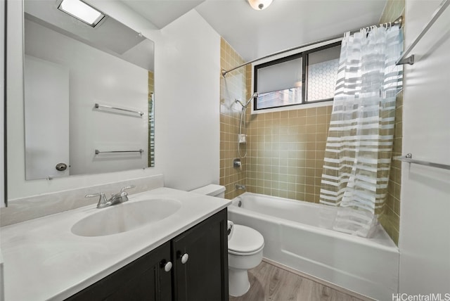 full bathroom with vanity, wood-type flooring, shower / tub combo, and toilet