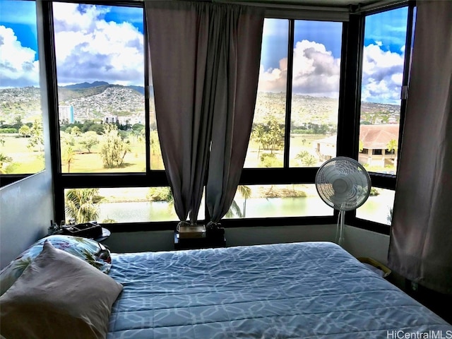 bedroom with a water and mountain view