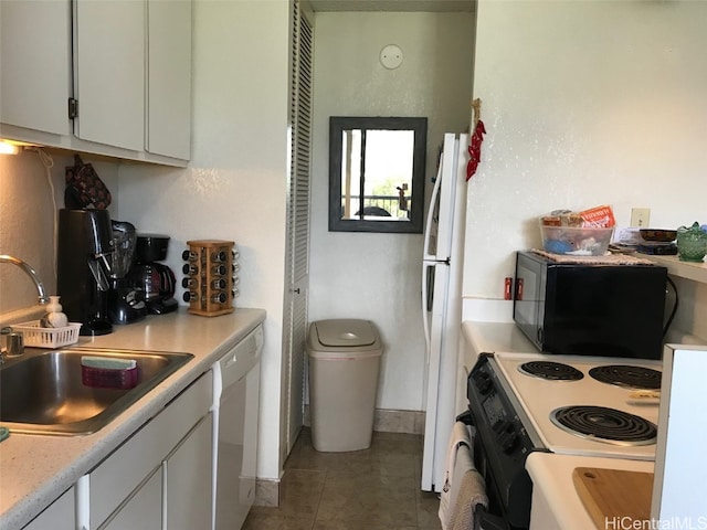 kitchen featuring white cabinetry, white appliances, sink, and tile patterned floors