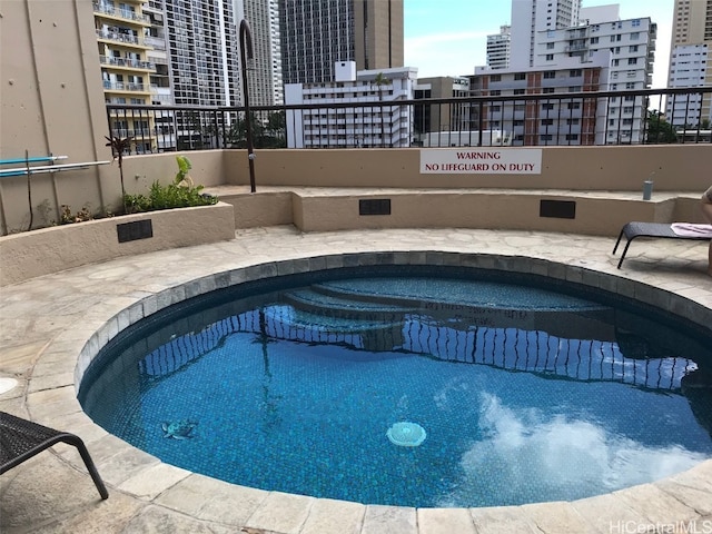 view of swimming pool with a community hot tub