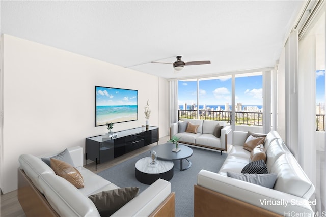 living room featuring ceiling fan and floor to ceiling windows