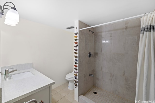 bathroom featuring toilet, a shower with curtain, vanity, and tile patterned floors