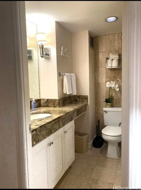 bathroom with toilet and vanity