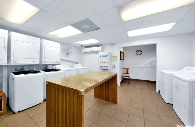 440 Olohana St Unit 1808, Honolulu, HI 96815 - communal laundry room featuring stacked washer / dryer, independent washer and dryer, light tile patterned floors, and a wall mounted AC