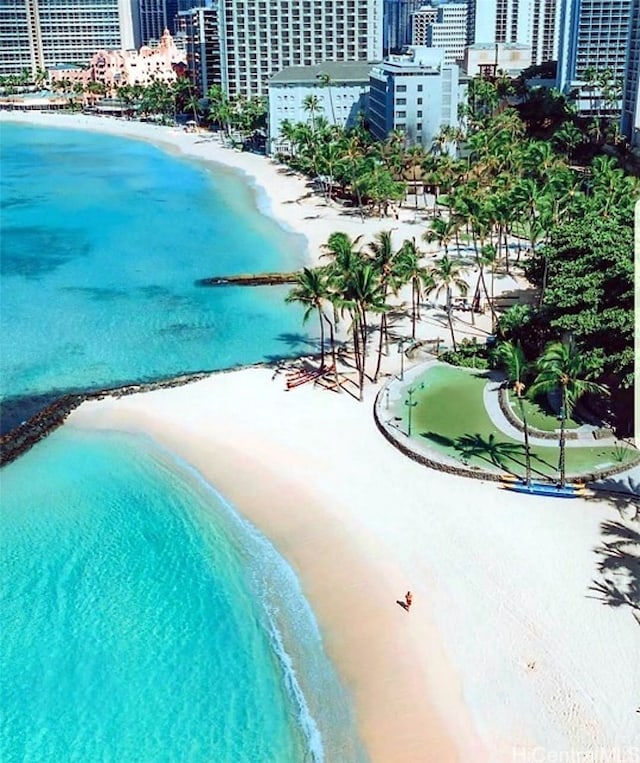 view of pool with a view of the beach and a water view