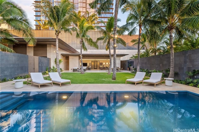 view of swimming pool with a lawn and a patio area