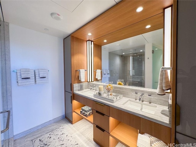 bathroom featuring decorative backsplash, hardwood / wood-style floors, vanity, and a shower with shower door