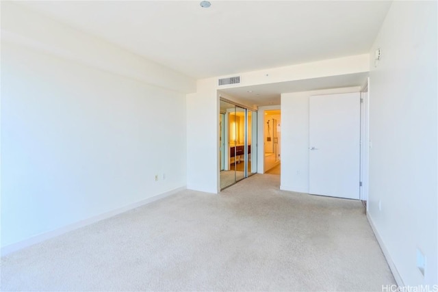 empty room with light colored carpet