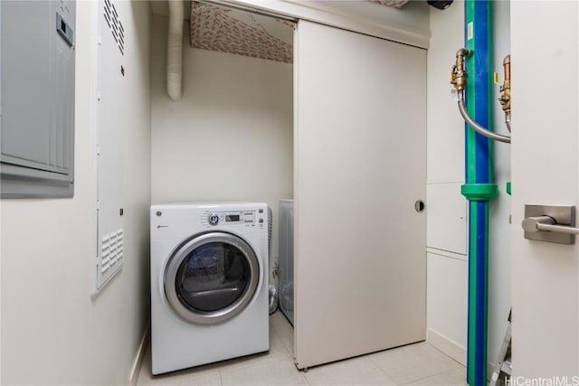 clothes washing area with light tile patterned flooring and washer / dryer