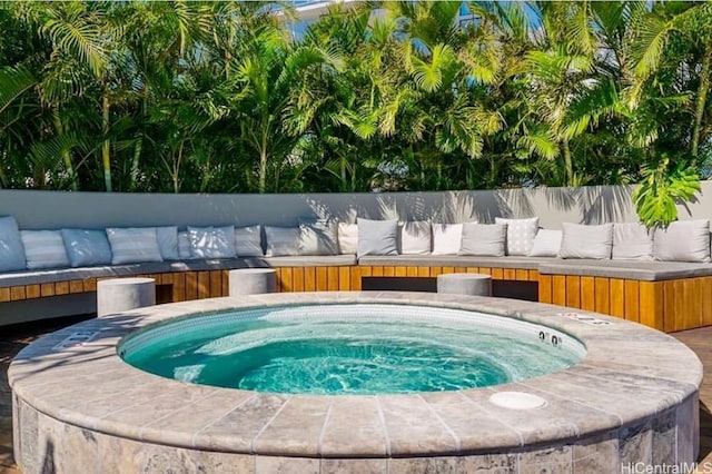 view of swimming pool featuring an outdoor hot tub and an outdoor hangout area