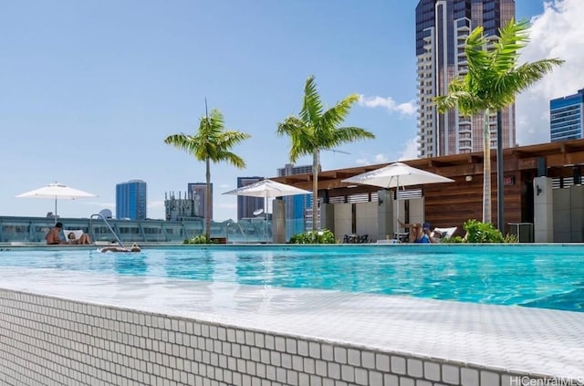 view of swimming pool with pool water feature