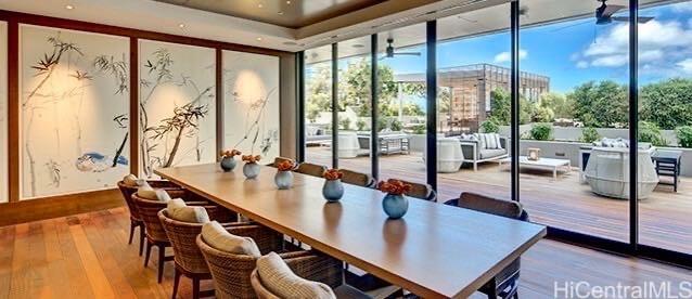 interior space featuring expansive windows and wood-type flooring