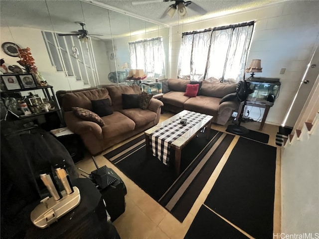 living room featuring ornamental molding, a textured ceiling, and ceiling fan