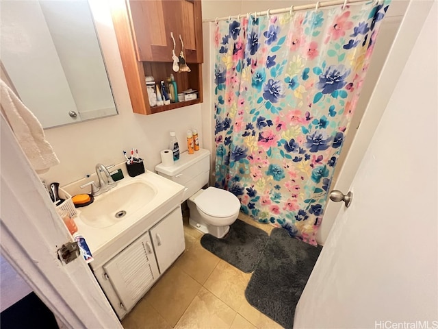 bathroom featuring toilet, vanity, tile patterned flooring, and curtained shower