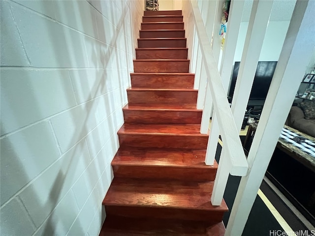 stairway with hardwood / wood-style floors