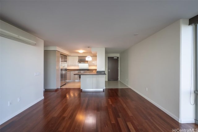 unfurnished living room with dark hardwood / wood-style floors